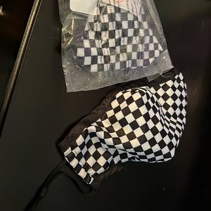 Brand new, in plastic, checkerboard facemask.